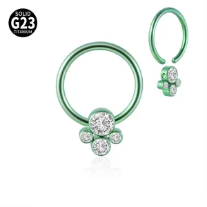 Close-up of professional G23 titanium green BCR nose ring with CZ stone cluster detail