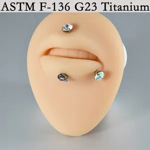 Professional G23 titanium labret piercing studs with shiny zirconia on a lip model