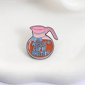 Detailed view of pink coffee pot enamel pin with Pour Myself a Cup of Ambition