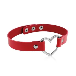 Close-up of red leather choker featuring a silver heart-shaped metal buckle detail