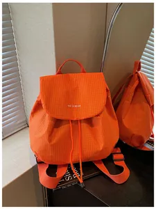 Detail view of orange checkered casual backpack with drawstring and You Ji Bear print
