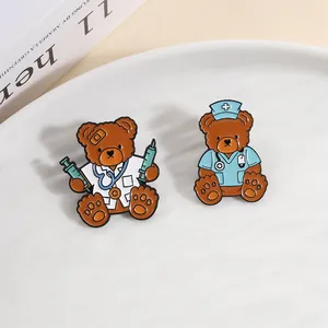 Close-up of cute cartoon doctor and nurse teddy bear enamel pins on a white plate