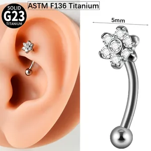 Close-up detail of 5mm flower zircon G23 titanium curved barbell eyebrow piercing