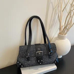A close-up view of the vintage grey patterned baguette bag with silver studs and buckle