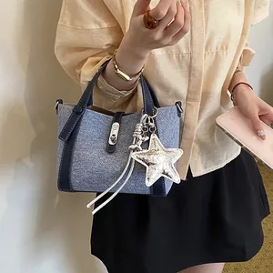Detailed view of stylish denim texture bucket bag featuring a silver star charm accessory