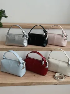 Retro-style pillow handbags in six colors featuring metallic chain detail and straps
