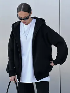Detail view of a premium oversized black zip-up hoodie for women in a street style