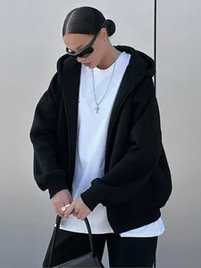 Detailed shot of women's oversized black zip-up hoodie and matching sweatpants set.