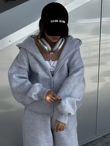 Macro view of grey two-piece tracksuit featuring a zip-up hoodie and matching joggers set.