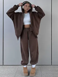 Detail view of brown oversized hooded zip-up sweatshirt and matching sweatpants set