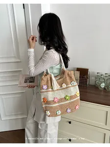 Handmade crochet tote bag with colorful floral decorations for summer beach vacations