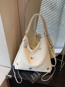 Chic cream large capacity commuter bag featuring silver butterfly studs and bunny charm
