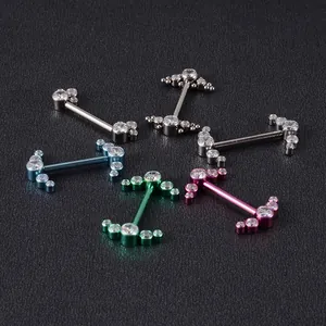 Detailed macro shot of G23 titanium nipple rings with colorful plating and clear gems