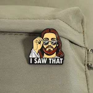 Close-up of funny 'I SAW THAT' enamel pin on a green fabric backpack.