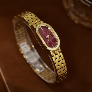 Elegante Vintage-Damenuhr aus goldfarbenem Edelstahl mit tiefrotem ovalem Zifferblatt