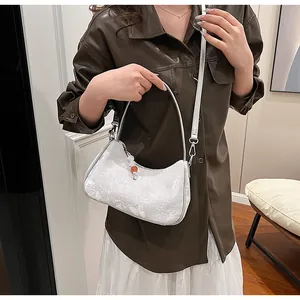Elegant white lace underarm hobo bag featuring a delicate bead charm accessory.