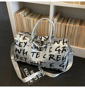 Silver graffiti travel bag with GREY-WHITE print shown in a lifestyle interior setting