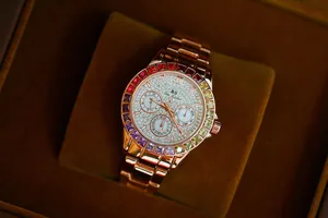 Detailed view of luxury rose gold watch with rainbow gemstone bezel and crystal dial
