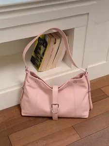 Chic pink underarm shoulder bag with buckle detail and modish hobo style silhouette