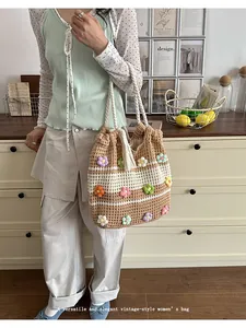 Handmade crochet tote bag with colorful flower patterns shown in a vintage lifestyle setting