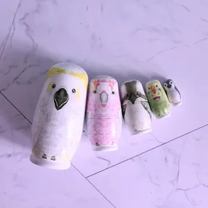 Hand-painted wooden Russian nesting dolls set featuring five colorful cartoon bird designs