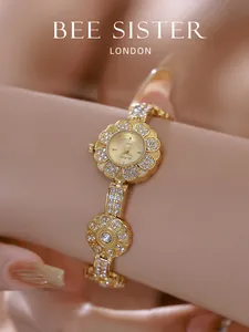 Detailed macro view of an exquisite gold floral bracelet watch with shiny crystal petals