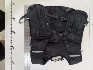 Macro detail of a black multifunctional running vest with a ruler showing size scale