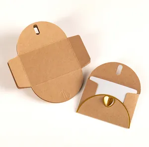Macro view of vintage kraft paper envelope with gold foil heart and white insert card