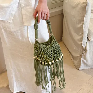 Detailed view of handmade green macramé bucket bag with wooden beads and long fringe