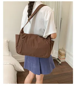 Large capacity minimalist brown nylon crossbody tote bag for women travel or daily use.