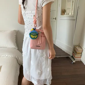 Pink mesh bucket bag with drawcord and cute banana charm for women fashion.