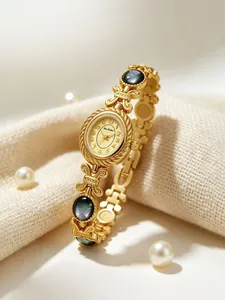 Primer plano detallado de un reloj de pulsera dorado vintage con detalles de nácar negro