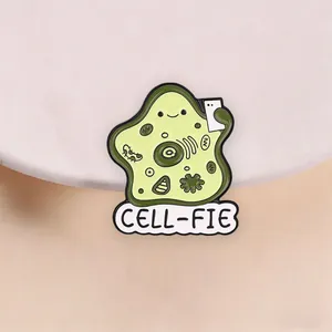 Detailed macro view of a cute Cell-fie cartoon biology enamel pin with funny pun text