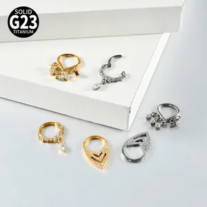 Detailed view of G23 titanium nose rings and earrings with sparkling zircon accents