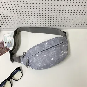 Detail view of gray star pattern fanny pack with KPXB logo and adjustable strap.