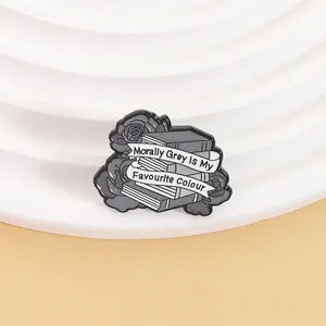 Détail du pin's "Morally Grey is My Favourite Colour" avec motif de livre et rose
