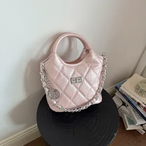 Elegant pink quilted bucket bag with a metallic finish and stylish silver chain strap