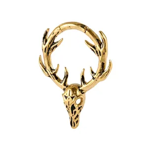 Boucle d'oreille vintage en acier inoxydable doré avec crâne de cerf et bois.