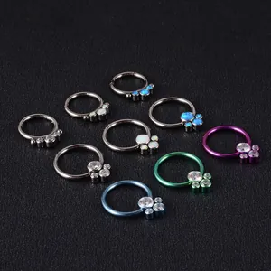 Collection of G23 titanium nose rings with opal and CZ stone clusters in multiple colors