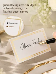 Close-up of gold foil wedding place card with guest name and fountain pen detail