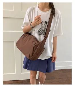Lightweight brown large-capacity crossbody bag for women shown on model in a daily scene