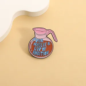 Detailed macro view of a pink coffee pot enamel pin featuring a motivational quote.
