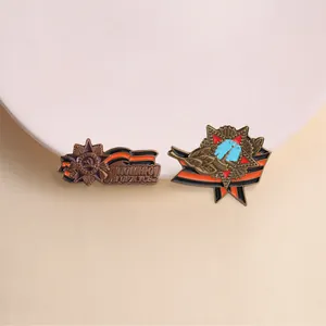 Close-up of vintage Soviet-style metal badges with St. George's ribbon and star motifs.