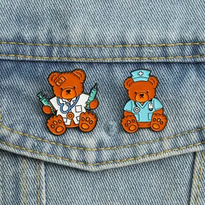 Detailed close-up of cartoon teddy bear doctor and nurse enamel pins on denim jacket fabric