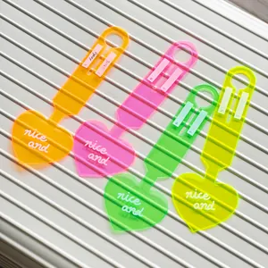 Set of four neon PVC heart-shaped luggage tags for suitcases in vibrant assorted colors