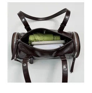 Detailed view of the spacious interior capacity of this vintage brown cylinder shoulder bag