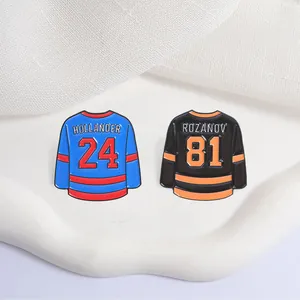 Detailed view of hockey jersey enamel pins featuring Hollander 24 and Rozanov 81 designs
