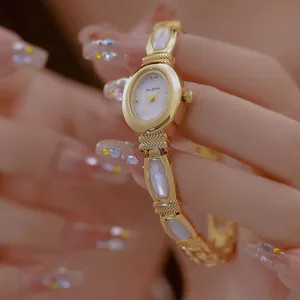 Elegante reloj de pulsera Bee Sister dorado con esfera de nácar blanco