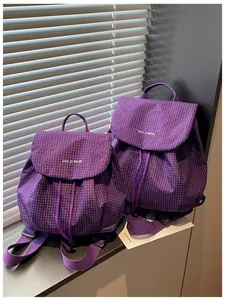 Detail view of purple plaid casual backpacks with YOU JI BEAR logo and drawstring design