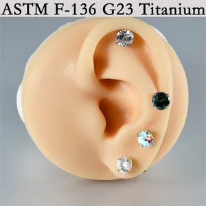 G23 titanium labret studs with shimmering zircons on a silicone ear model
